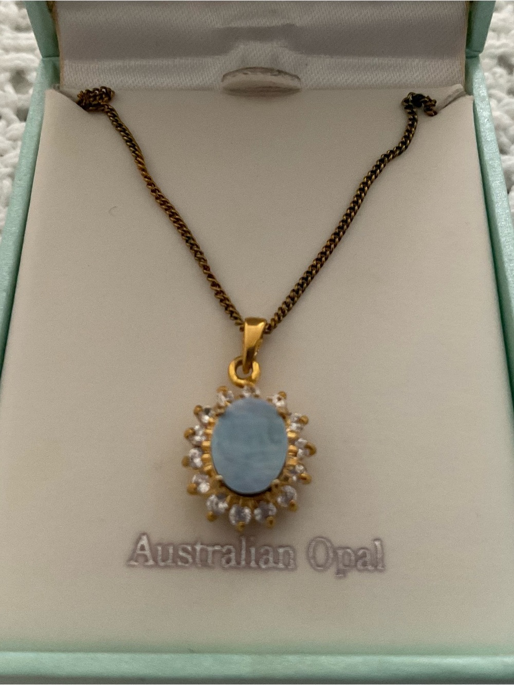 Gold-Tone Pendant Necklace with Light Blue Opal Halo